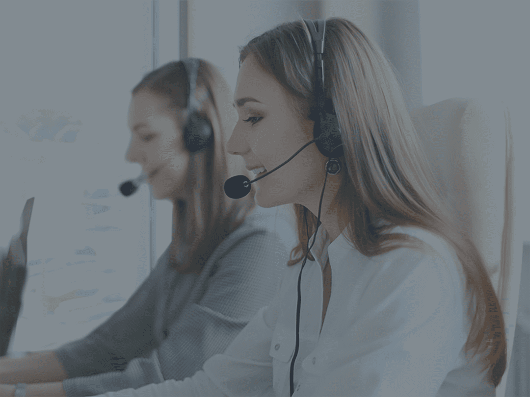 Customer service center, two women with headsets.