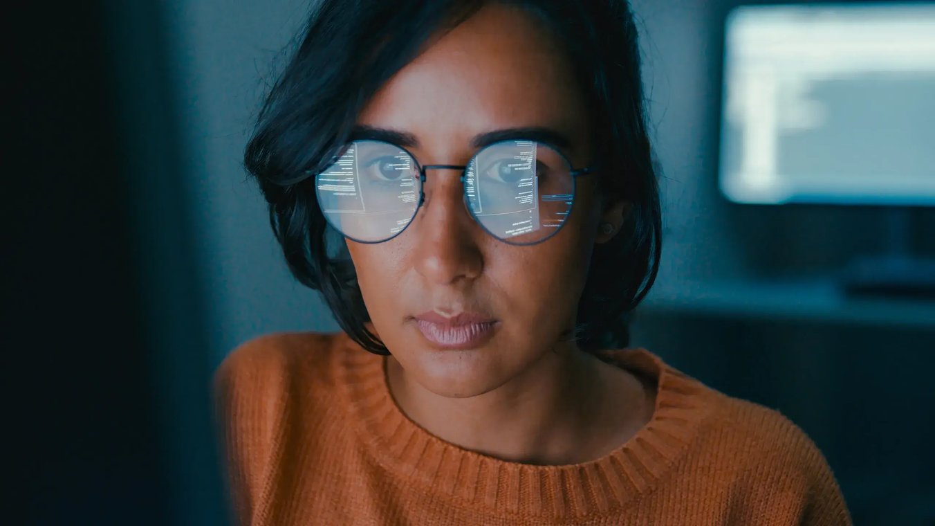 cyber-security-close-up-of-woman-with-coding-reflection-in-glasses
