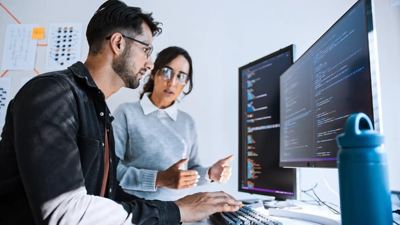 cyber-security-man-and-woman-discussing-code-gesturing
