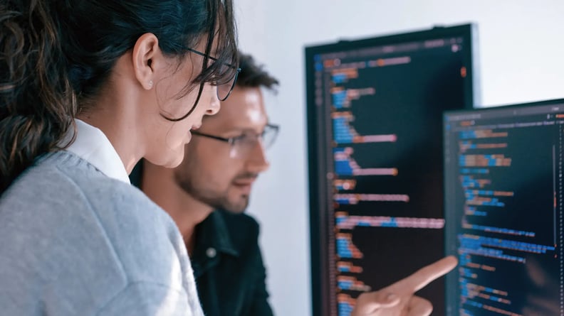 cyber-security-woman-and-man-discussing-code-pointing