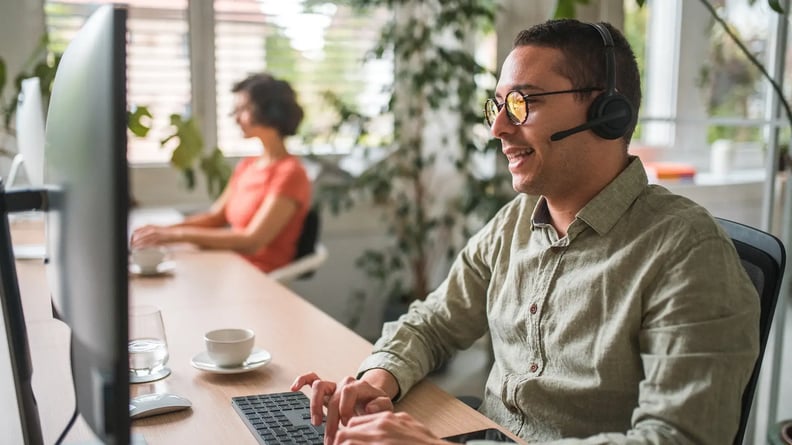 esm-customer-service-man-headset-typing