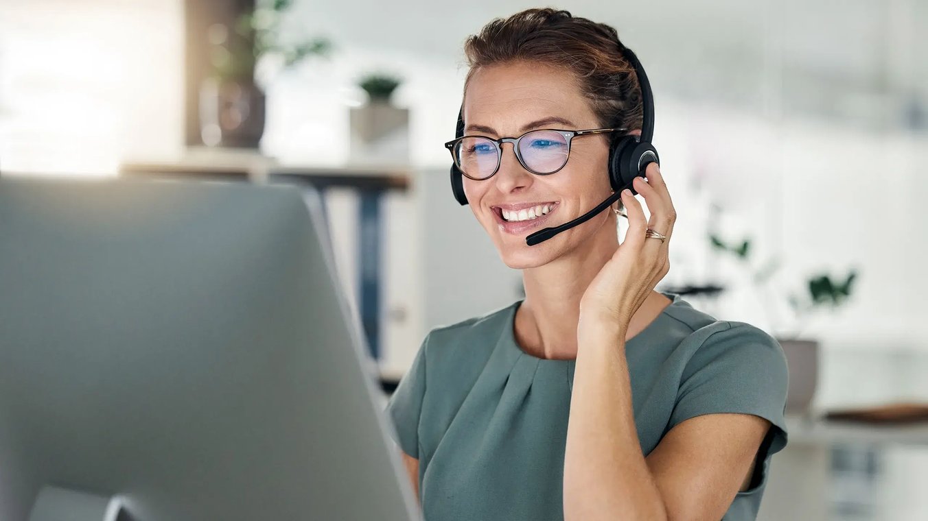 esm-customer-service-woman-touching-headset-smiling