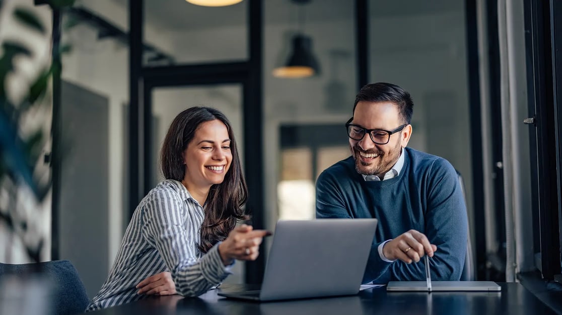 esm-people-man-woman-smiling-desk-conversation-work-environment