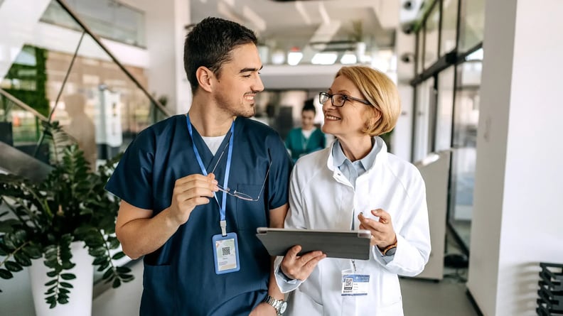 esm-healthcare-nurse-and-doctor-walking-and-smiling