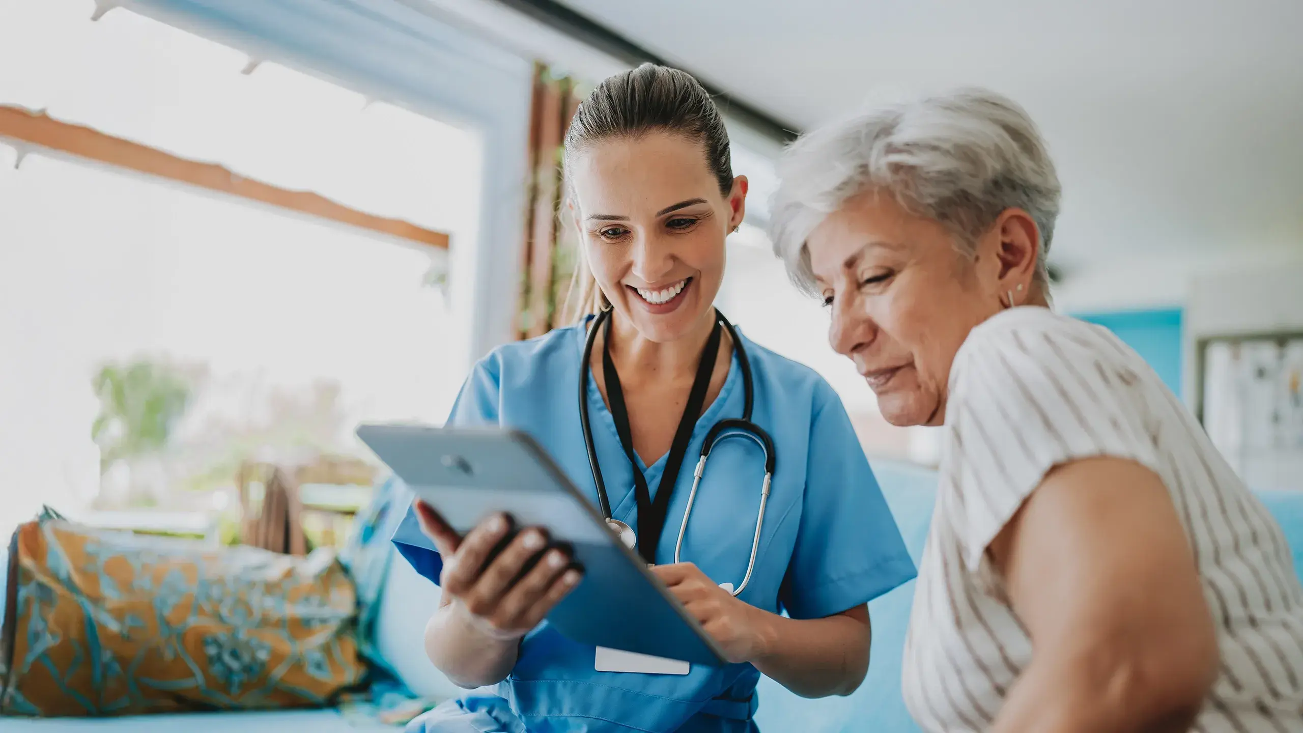 esm-healthcare-nurse-and-elderly-looking-at-tablet