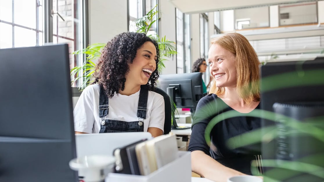 esm-hr-two-women-laughing-in-office