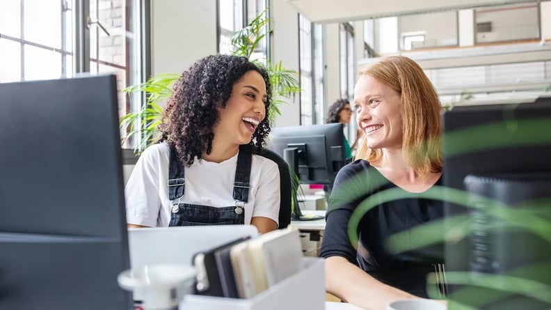 esm-hr-two-women-laughing-in-office