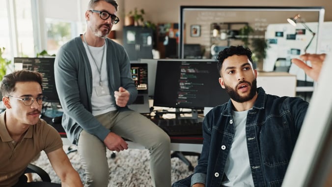 esm-itsm-three-man-discussing-code