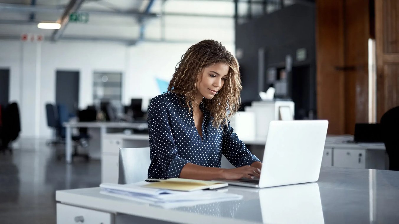 esm-itsm-woman-working-on-laptop-in-empty-office