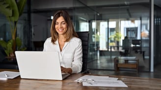 financial-woman-smiling-with-laptop
