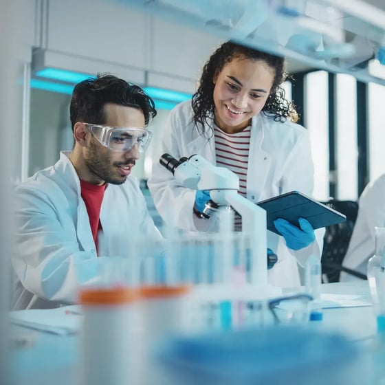 esm-healthcare-man-and-woman-in-laboratory-looking-at-microscope-square