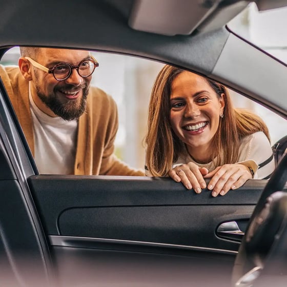 industry-man-and-woman-looking-into-car-interior-square