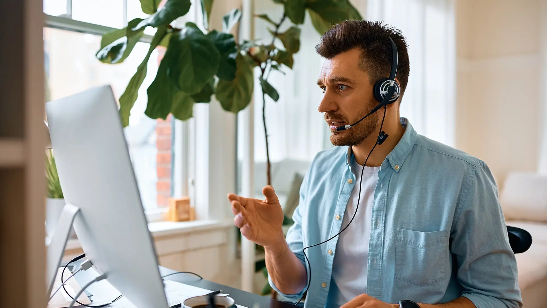 man talking on a headset in a green work environment