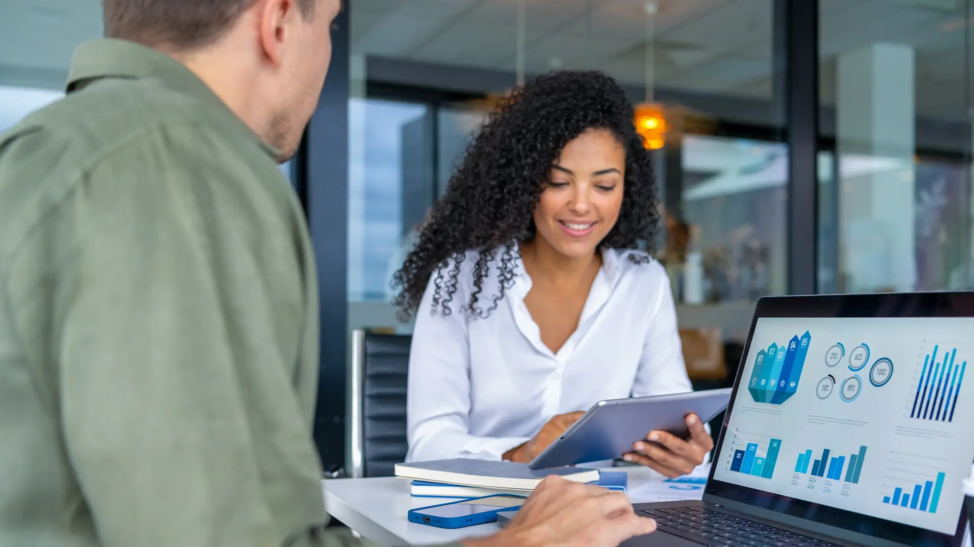 team working together on graphs at office desk