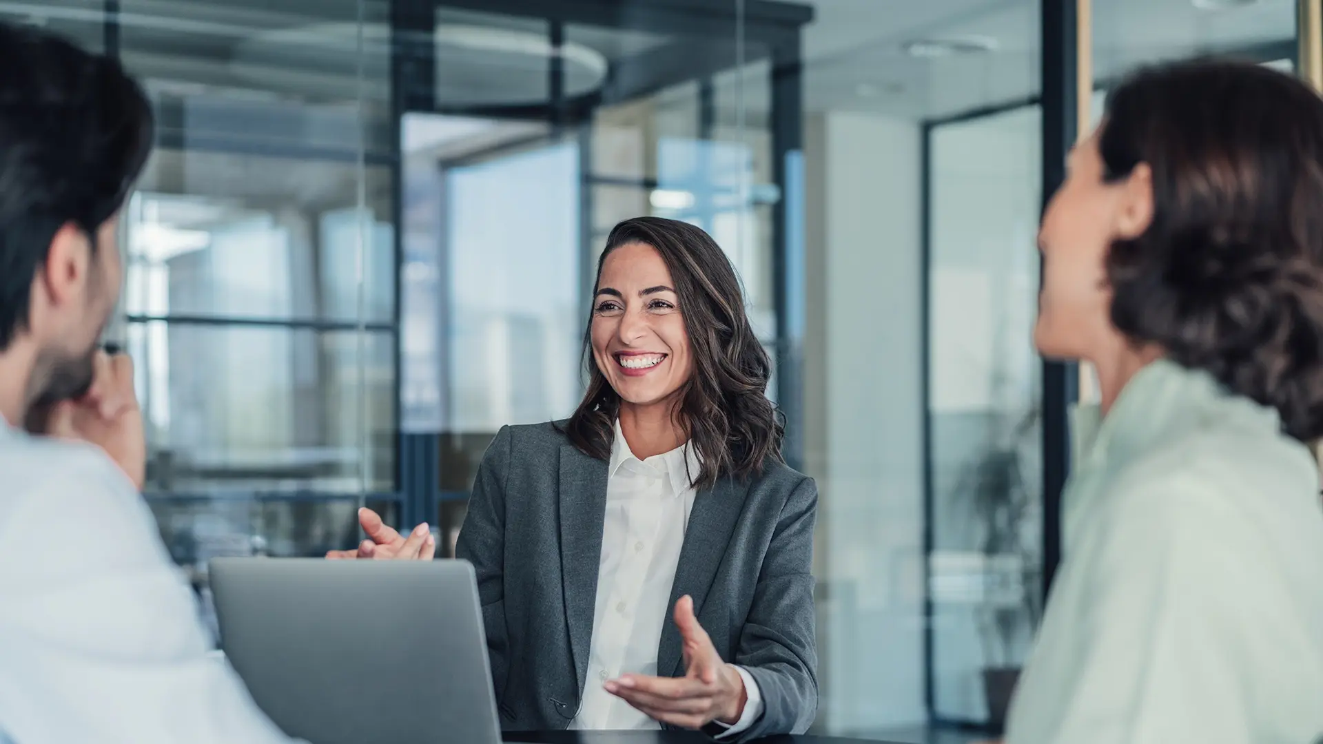 woman smiling at desk in conversation
