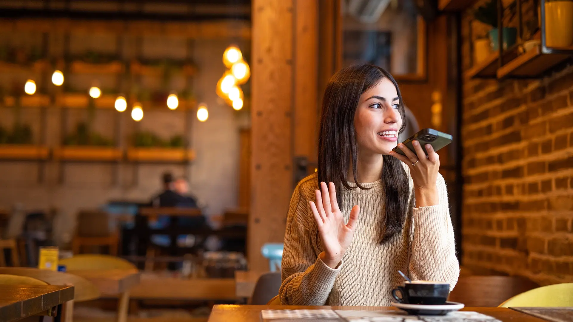 woman sitting in a café using smartphone in public
