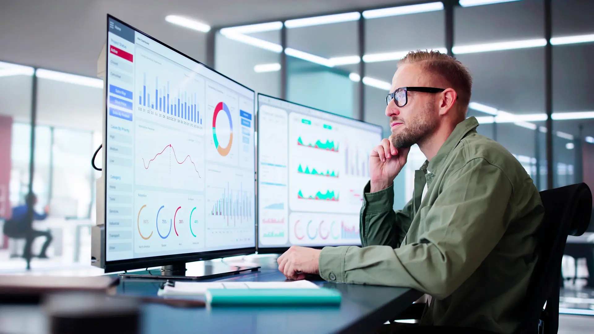man working with statistical data on monitor