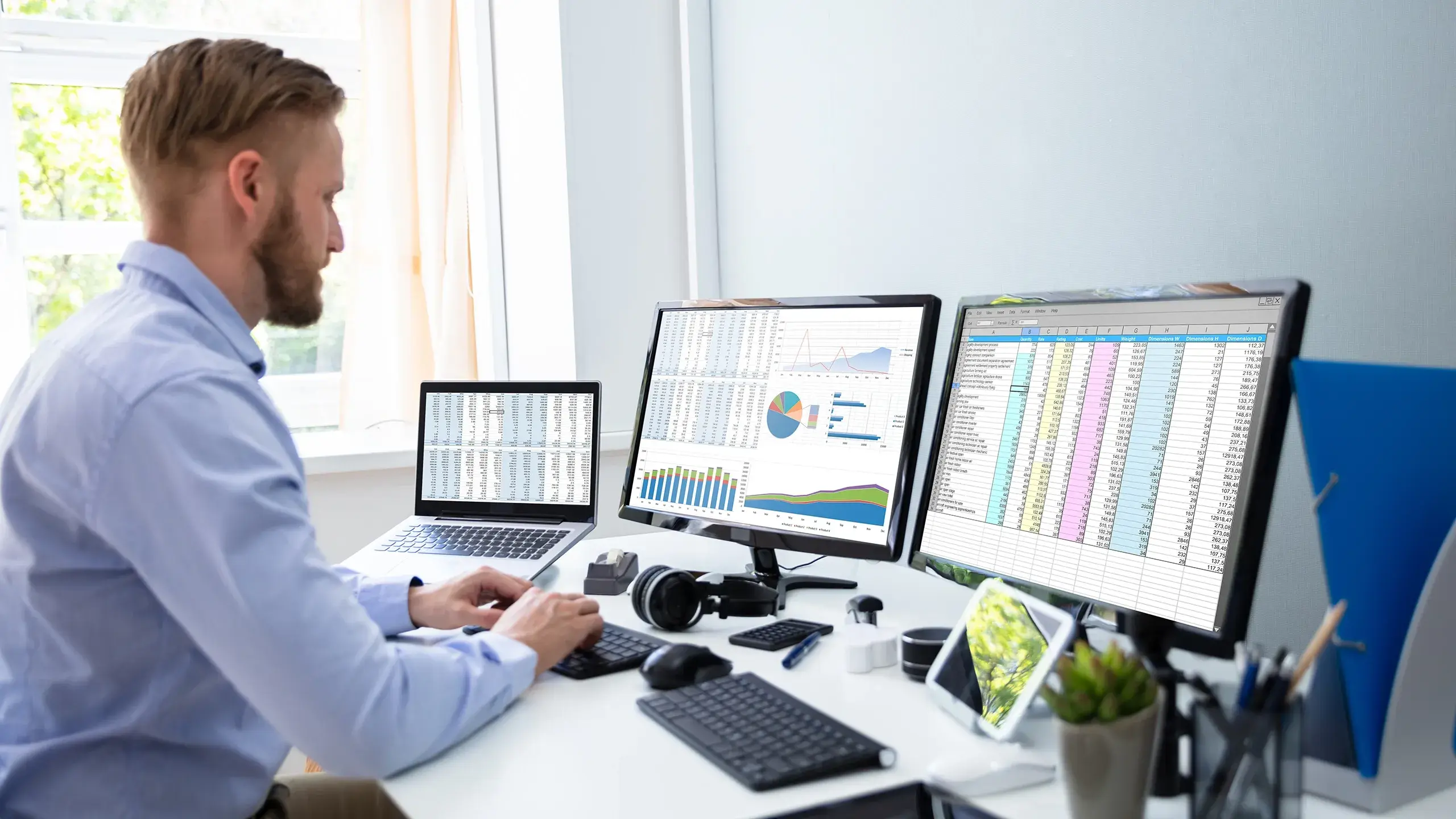 IT Controller looking at three screens to sort out IT cost allocation